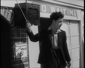 A Young Man in a Suit With an Open-Necked Shirt and Holding a Stick in One Hand is Drumming..., 1938 Creator: British Pathe Ltd.