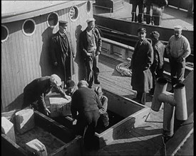 Male Civilians Unloading Illegal Cargo from a Boat, 1932. Creator: British Pathe Ltd.