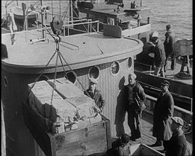 Male Civilians Unloading Illegal Cargo from a Boat, 1932. Creator: British Pathe Ltd.