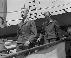 Two Captured German Pilots Being Escorted Down a Gangplank, 1940. Creator: British Pathe Ltd.