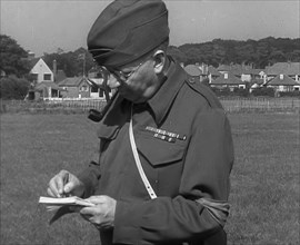 A British Local Defence Volunteer Writing Notes, 1940. Creator: British Pathe Ltd.