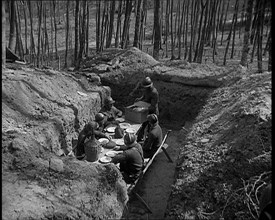 French Soldiers Eating a Meal in a Dug Out, 1940. Creator: British Pathe Ltd.