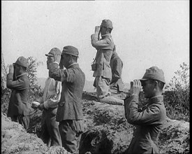 Japanese Soldiers in a Trench Looking Through Binoculars, 1937. Creator: British Pathe Ltd.