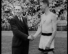 Jack Lovelock Shaking Hands With Someone as Crowds Watch, 1930s. Creator: British Pathe Ltd.