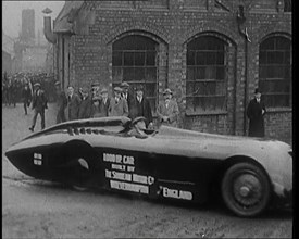 Sir Henry Segrave AKA Major Segrave's Driving  'Sunbeam' Out of a Factory Watched By a..., 1927. Creator: British Pathe Ltd.