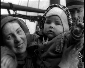 Dutch Refugees Fleeing Aboard Ships in the Netherlands. A Woman Holding Her Baby Is..., 1940. Creator: British Pathe Ltd.