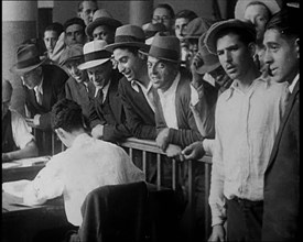 A Crowd of People Inside an Employment Agency Asking For Work, 1932. Creator: British Pathe Ltd.