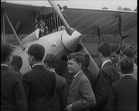 A Group of Young Male British Civilians Admiring an Airplane On an Airfield, 1920s. Creator: British Pathe Ltd.