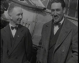 Clarence Duncan Chamberlin And Bertrand Blanchard Acosta Talking in Front of an Airplane, 1920s. Creator: British Pathe Ltd.