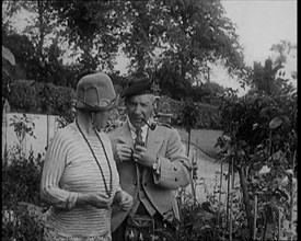 Sir Harry Lauder Giving Flowers to His Wife, Lady Ann Lauder, at Home in Scotland, 1920s. Creator: British Pathe Ltd.