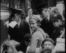 British Male and Female Evacuees Waiting to Board a Bus With Two Male Bus Staff Standing..., 1939. Creator: British Pathe Ltd.