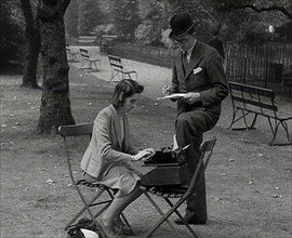 A Man and Woman Taking Notes in a Park, 1941. Creator: British Pathe Ltd.