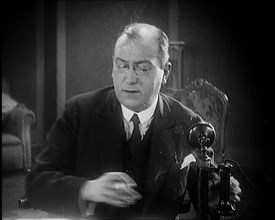 The Producer Julian Wylie Speaking on a Telephone, 1920s. Creator: British Pathe Ltd.