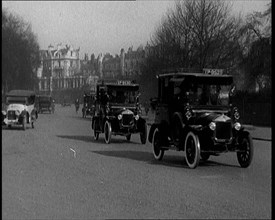 Taxis Drive Down a London Street, 1924. Creator: British Pathe Ltd.