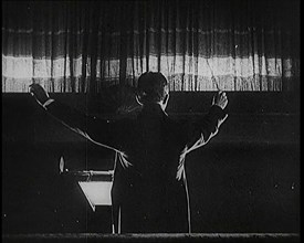 Conductor and Orchestra Performing As the Curtain Raises, 1920s. Creator: British Pathe Ltd.