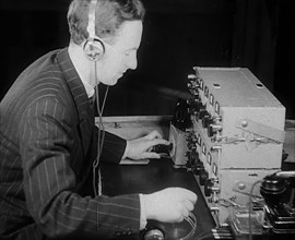 A Man Operating a Radio, 1940. Creator: British Pathe Ltd.