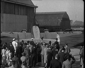 A Small Crowd at Heston Aerodrome Cheering the Moving Lockheed Aeroplane Carrying the..., 1938. Creator: British Pathe Ltd.