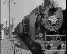 A Train Pulling Into a Station as Assorted Military Men Are Standing on the Platform, 1939. Creator: British Pathe Ltd.