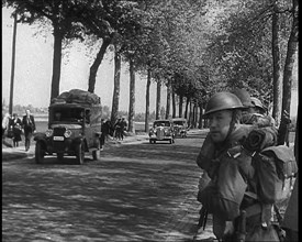 French Refugees Fleeing Town Down Country Roads, British Forces Moving Past Them, 1940. Creator: British Pathe Ltd.