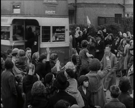 Women, Children, and Men Waving Goodbye to Children Being Evacuated by Bus, 1939. Creator: British Pathe Ltd.