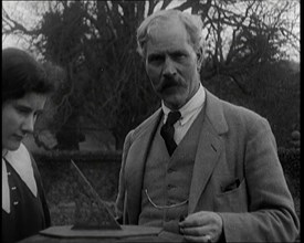 Ramsay MacDonald and His Daughter Ishbel Allan MacDonald Standing Beside a Sundial in a Garden,1920s Creator: British Pathe Ltd.