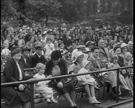 British People Watching Chimpanzees Having a Tea Party at the Zoo, 1940. Creator: British Pathe Ltd.