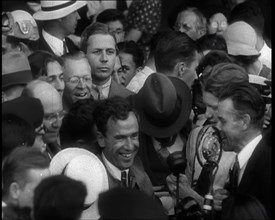 Jim Mollison Walking Surrounded by a Large Crowd, 1930s. Creator: British Pathe Ltd.