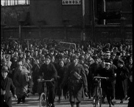 Chinese Refugees Including Several With Bicycles Spilling Through Barriers..., 1937. Creator: British Pathe Ltd.