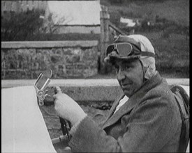 Close up Shot of John Godfrey Parry-Thomas Behind the Wheel of a Car Wearing a Racing Helmet, 1927. Creator: British Pathe Ltd.