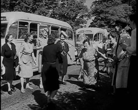 A Group of British Women Dancing On a Grass Verge in the Sunshine With Two Buses Parked..., 1938. Creator: British Pathe Ltd.