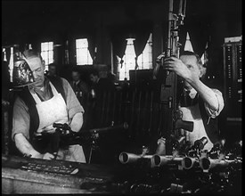 Two Men Making Machine Guns in a Factory, 1940. Creator: British Pathe Ltd.