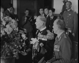 British and Japanese Military Leaders Sitting and Standing Around a Table, 1937. Creator: British Pathe Ltd.