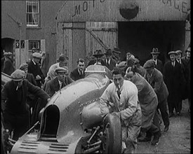 A Crowd of Civilians Watching a Group of Civilians Wheeling Malcolm Campbell's 'Bluebird'..., 1927. Creator: British Pathe Ltd.