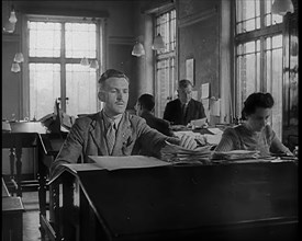 People Working in an Office, 1940. Creator: British Pathe Ltd.