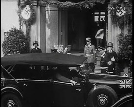 Adolf Hitler, the German Leader Coming Out of a Building in Bad Godesburg With Male German..., 1938. Creator: British Pathe Ltd.