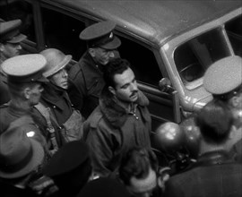 A Captured Italian Pilot Being Escorted Through a Train Station, 1940. Creator: British Pathe Ltd.