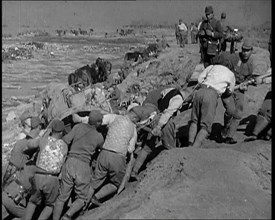 Male Japanese Soldiers Hauling a Cart up a Beach Near Shanghai, 1937. Creator: British Pathe Ltd.