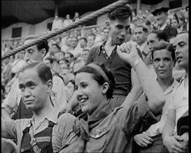 Spectators at Bullring Cheering Parading Government Fighters, Including Woman With Raised..., 1937. Creator: British Pathe Ltd.