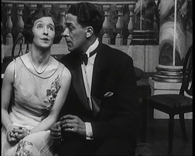 Jack Buchanan and June Knight Sitting on a Bench Together. Buchanan Looking Uncomfortable...,1920s Creator: British Pathe Ltd.