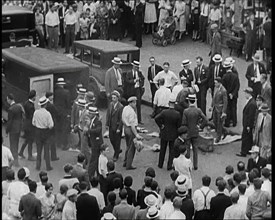 Crowded New York City Street Where Police and Ambulance Attend to Dead and Dying Victims..., 1932. Creator: British Pathe Ltd.