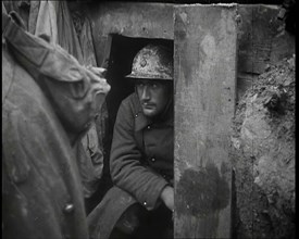 A Male French Soldier Sitting in a Doorway Dug into the Side of a Trench, 1939. Creator: British Pathe Ltd.