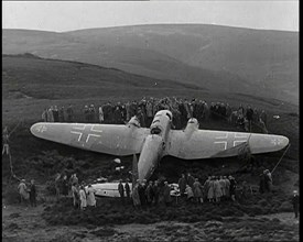 A Downed German Airforce Bomber Lying in a Scottish Field With a Rope Fence Around it and..., 1939. Creator: British Pathe Ltd.