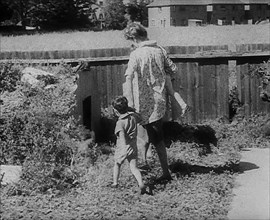 Woman Leading Her Children to an Air Raid Shelter, 1940. Creator: British Pathe Ltd.