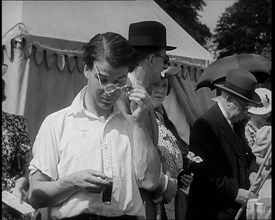 Emlyn Williams, Actor, Timing Punters by the 'Fishing for Fizz' Stall at  the Theatrical..., 1939. Creator: British Pathe Ltd.