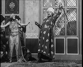 Scene from the Play 'Hassan': the Actor Henry Ainley in Full Costume Raising a Sword..., 1920s. Creator: British Pathe Ltd.