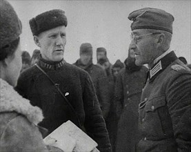 Two Russian Soldiers Talking to a German Prisoner of War, 1941. Creator: British Pathe Ltd.