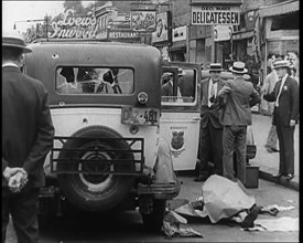 Crowded New York City Street Where Police and Ambulance Attend to Dead and Dying Victims..., 1932. Creator: British Pathe Ltd.