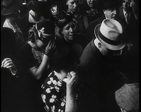 British Women and Men on a Crowded Railway Platform and Several Who Are Looking Upset, 1939. Creator: British Pathe Ltd.