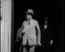 Two Male Civilians Emerging from a Building, 1924. Creator: British Pathe Ltd.