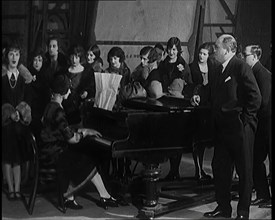 Female Civilian Singing Scales Badly Whilst Other Female Civilian is Playing the Piano in..., 1920s. Creator: British Pathe Ltd.